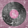 black vinyl record on pink dotted background
