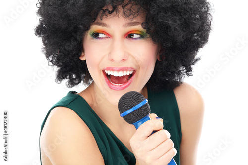 Photo: Woman with afro hairstyle holding microphone Woman with afro hairstyle holding microphone