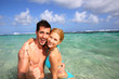 Couple in a caribbean lagoon showing thumbs up