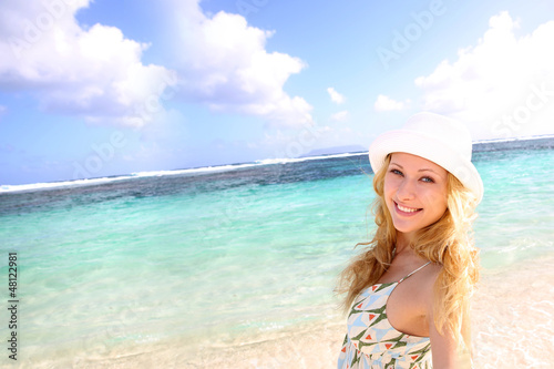 Photo: Smiling attractive girl at the beach Smiling attractive girl at the beach