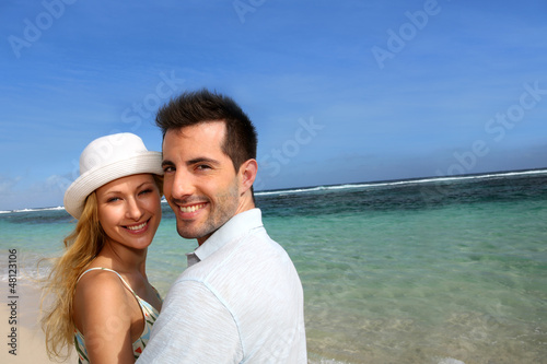 Photo: Portrait of cheerful couple at the beach Portrait of cheerful couple at the beach