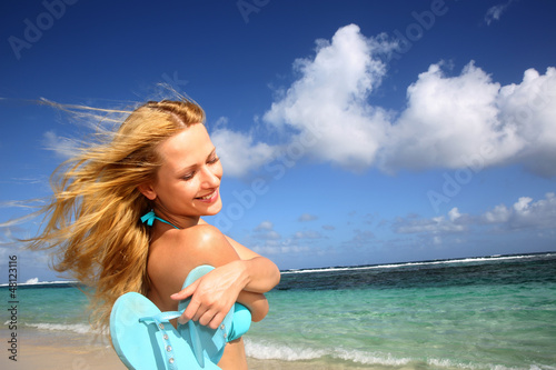 Photo: Beautiful girl suntanning by the beach Beautiful girl suntanning by the beach