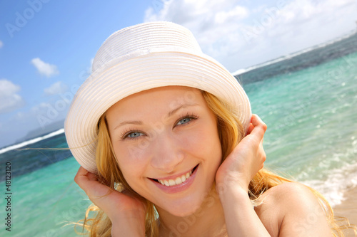 Photo: Smiling attractive girl at the beach Smiling attractive girl at the beach