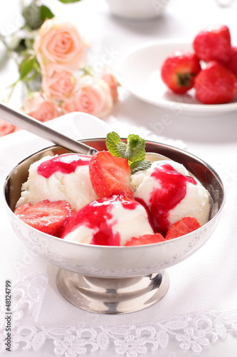 Photo: Ice cream with strawberries and sauce. Ice cream with strawberries and sauce.