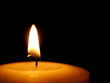 Single candle close - black background