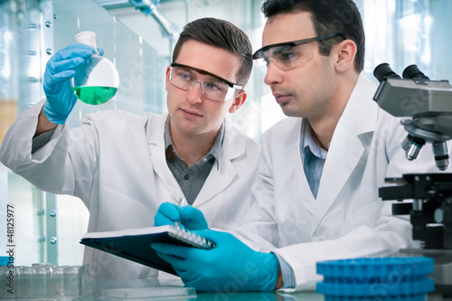 Photo: Scientists working in a research laboratory Scientists working in a research laboratory