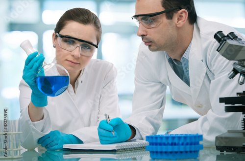Photo: Scientists working in a research laboratory Scientists working in a research laboratory