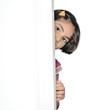 Shy little Indian / Asian  girl / kid hiding behind the door.