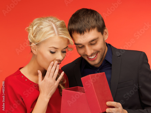 Photo: man and woman looking inside the gift box man and woman looking inside the gift box