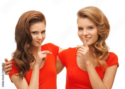 Photo: two teenage girls showing hush gesture two teenage girls showing hush gesture