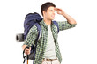 A hiker with backpack looking