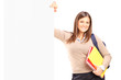 Photo: A smiling female student standing next to a billboard A smiling female student standing next to a billboard