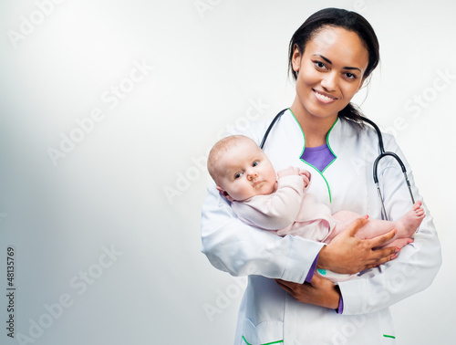Photo: Doctor and baby on a white background Doctor and baby on a white background