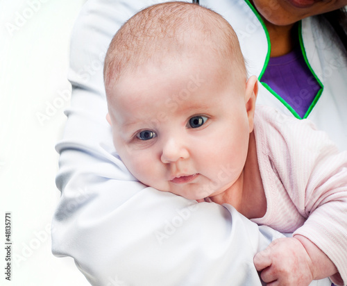 Photo: Doctor and baby on a white background Doctor and baby on a white background