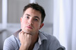 Man in home office with thoughtful look