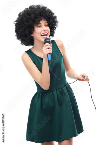 Photo: Woman with afro hairstyle doing karaoke Woman with afro hairstyle doing karaoke