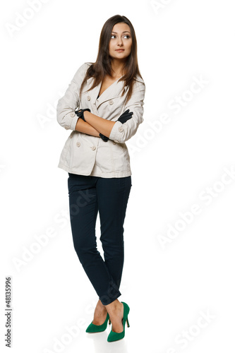 Photo: Full length of woman in jacket and gloves standing Full length of woman in jacket and gloves standing