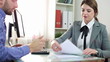 Businesswoman signing documents with client in the office