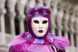 Person in Venetian costume attends Carnival of Venice.