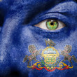Flag painted on face with green eye to show Pennsylvania support