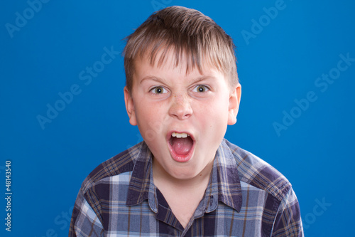 Photo: boy emotionally shouts boy emotionally shouts