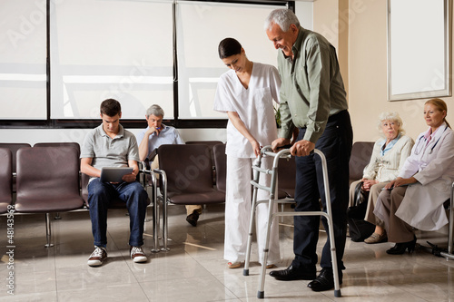Photo: Man Being Helped By Nurse To Walk Zimmer Frame Man Being Helped By Nurse To Walk Zimmer Frame