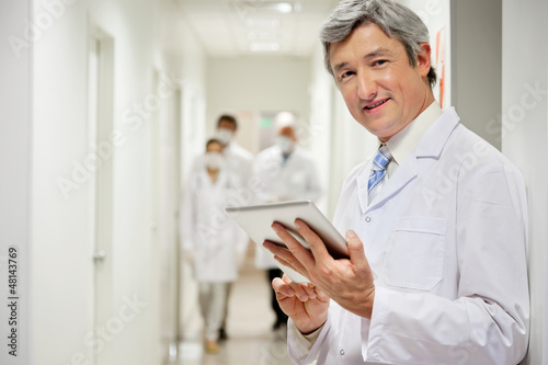 Photo: Doctor Holding Digital Tablet Doctor Holding Digital Tablet