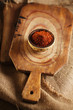 Photo: red hot chillies pepper flakes in bowl on wooden board backgro red hot chillies pepper flakes in bowl on wooden board backgro