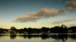 Timelapse of Evening Sky, lake, homes along river bank