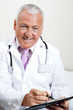 Doctor Writing On Clipboard