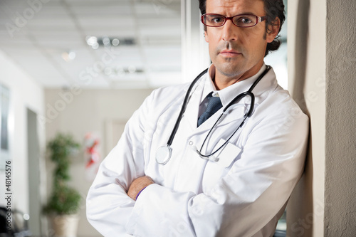 Photo: Doctor Standing With Hands Folded Doctor Standing With Hands Folded