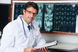 Photo: Radiologist At Desk With Clipboard Radiologist At Desk With Clipboard