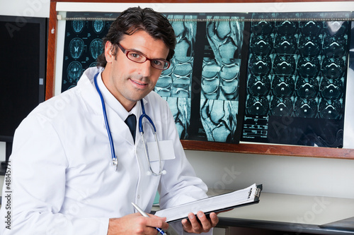 Photo: Radiologist At Desk With Clipboard Radiologist At Desk With Clipboard