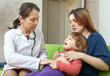 mature children's doctor examining  baby