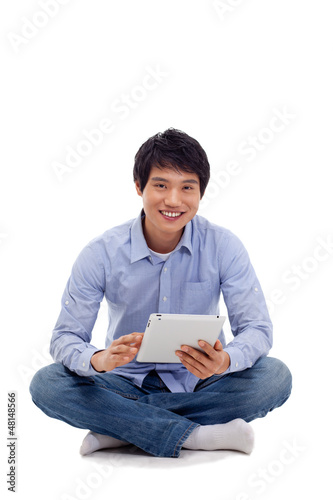 Photo: Asian man holding tablet computer isolated on white background. Asian man holding tablet computer isolated on white background.