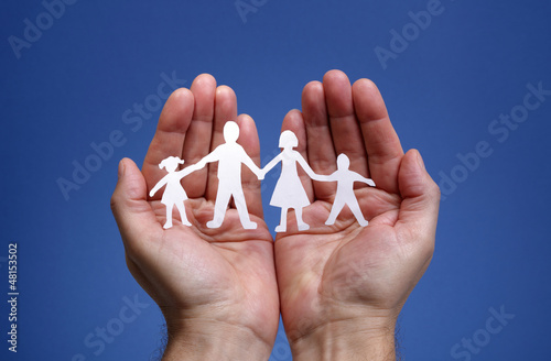 Photo: Paper chain family protected in cupped hands Paper chain family protected in cupped hands