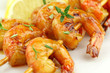 Glazed shrimp skewers with thyme and lemon closeup