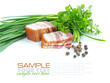 Pieces of bacon are with the bunch of green parsley