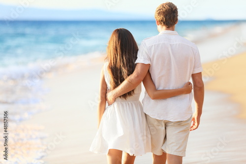 Photo: Vacation Couple Walking on Beach Vacation Couple Walking on Beach