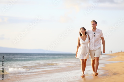 Photo: Couple walking on beach Couple walking on beach