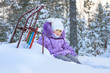 The little girl on a walk in the winter woods