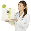 nutritionist showing a weight scale and green apple