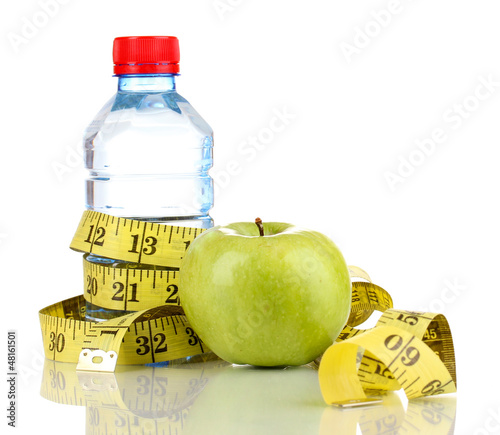 Photo: Bottle of water, apple and measuring tape isolated on white Bottle of water, apple and measuring tape isolated on white