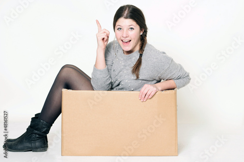 Photo: junges freches Mädchen sitzt in einem Karton junges freches Mädchen sitzt in einem Karton