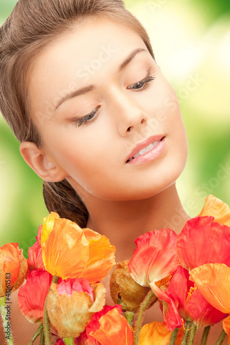 Photo: lovely woman with red flowers lovely woman with red flowers
