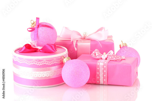 Photo: Colorful pink gifts with pink Christmas balls isolated on white Colorful pink gifts with pink Christmas balls isolated on white