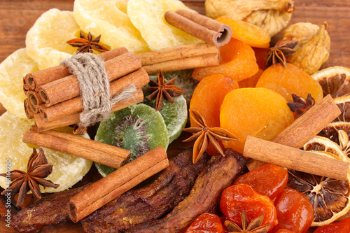 Photo: Dried fruits with cinnamon and anise stars close-up Dried fruits with cinnamon and anise stars close-up