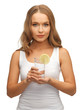 woman with lemon slice on glass of water