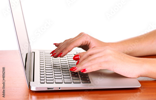 Photo: Detail of female hands using computer isolated on white Detail of female hands using computer isolated on white