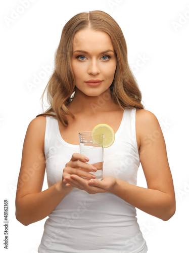 Photo: woman with lemon slice on glass of water woman with lemon slice on glass of water